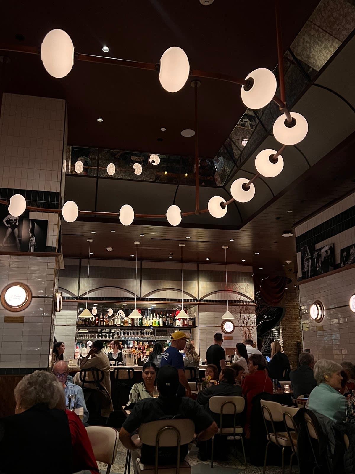 Interior of a lively cocktail bar with patrons and modern lighting in New York