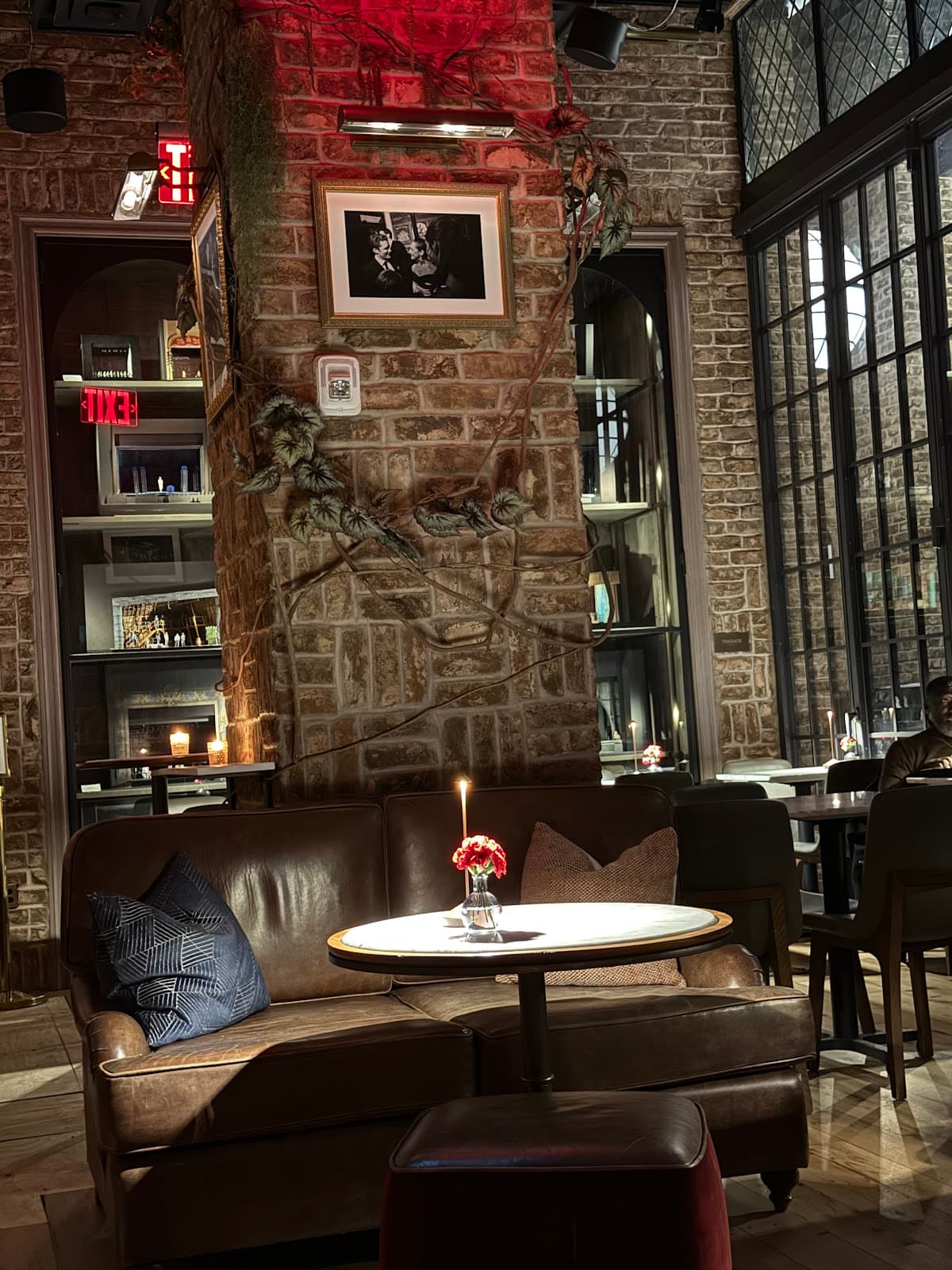 Cozy bar interior with leather sofa and decorative brick wall in New York