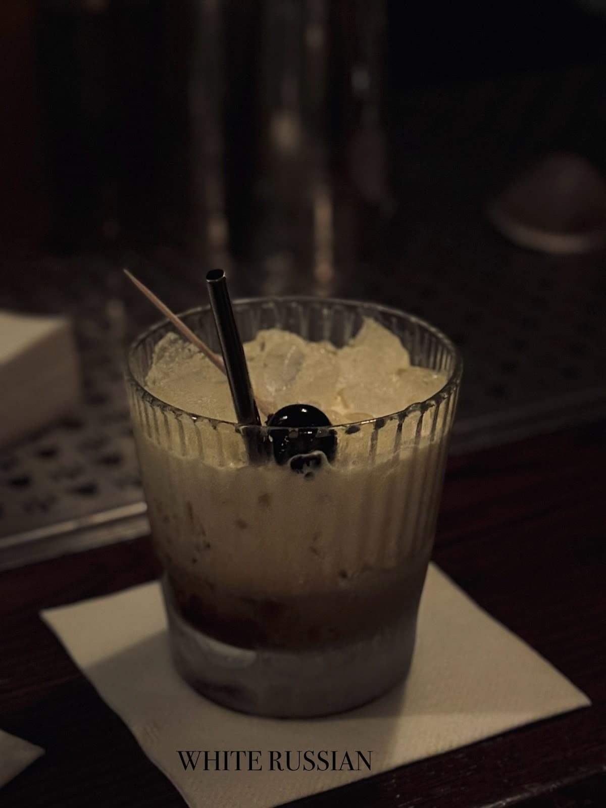 White Russian cocktail on a napkin with a straw and toothpick in London