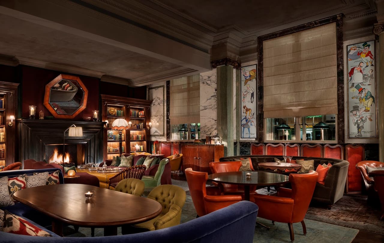 Luxurious cocktail bar interior with fireplace and plush seating