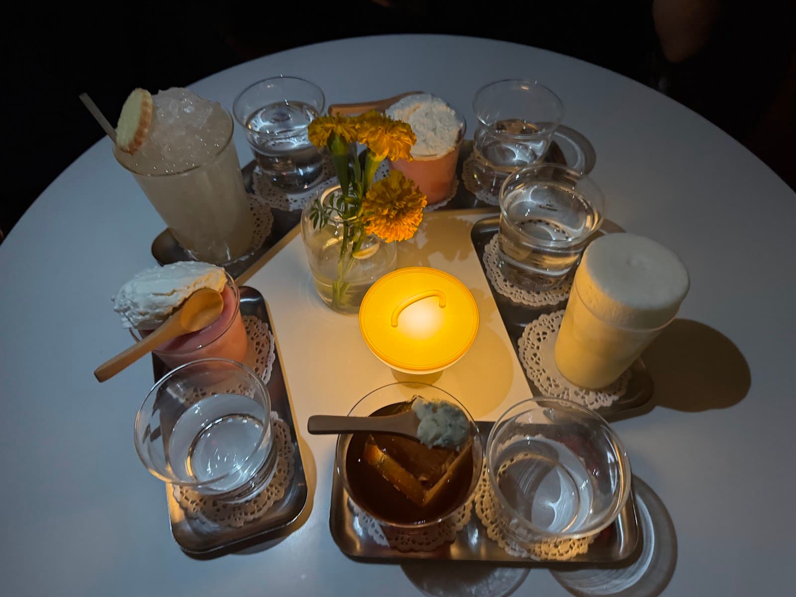 Candles and drinks set on a table with flowers in New York