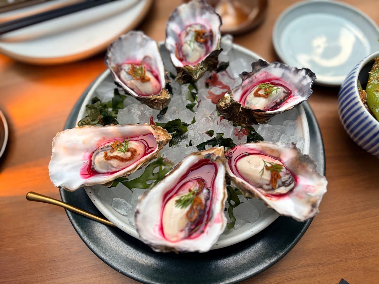 Close-up of a plate of oysters on ice with garnish in San Francisco