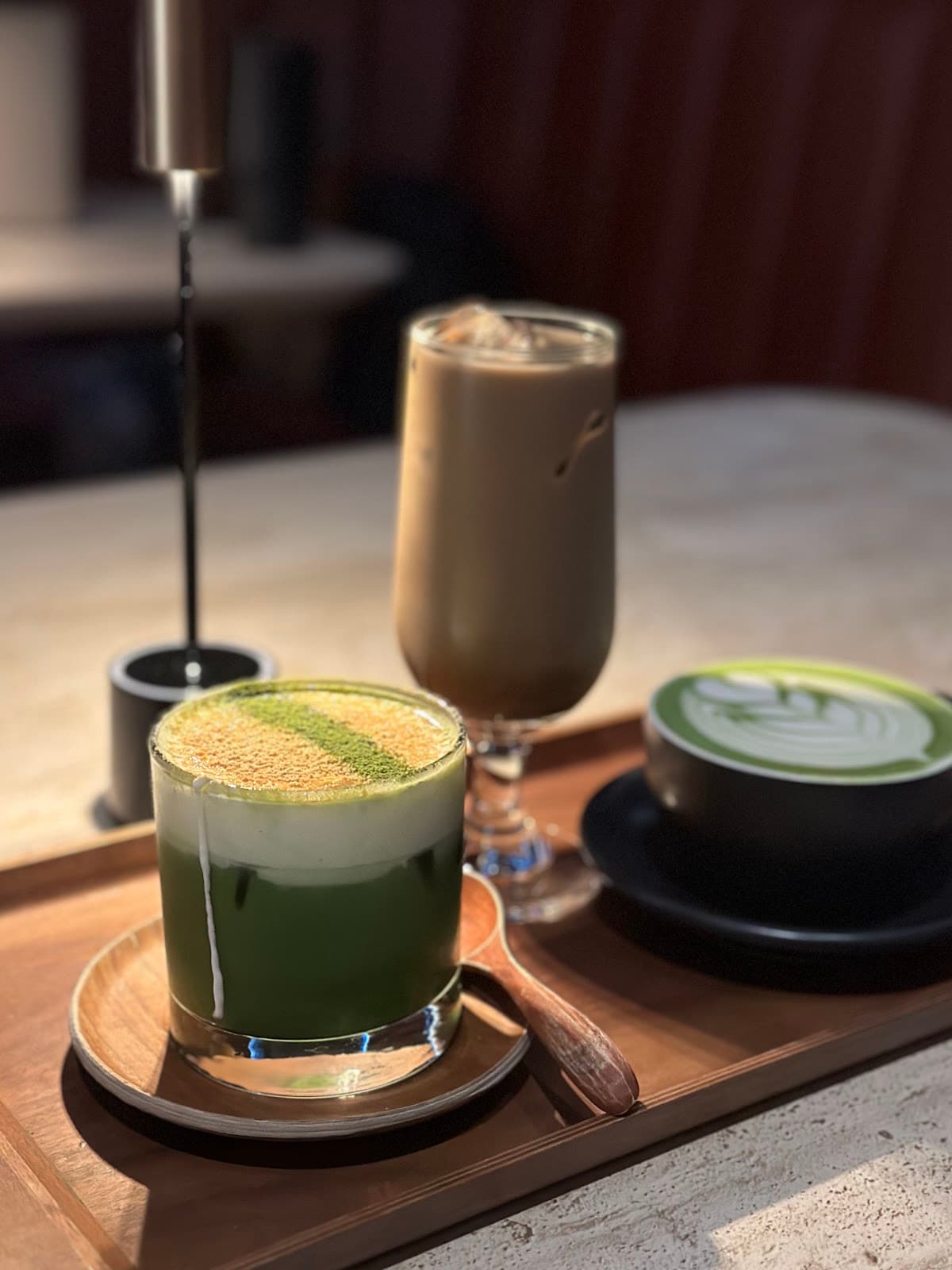Artistic presentation of drinks with matcha on a wooden tray in San Francisco