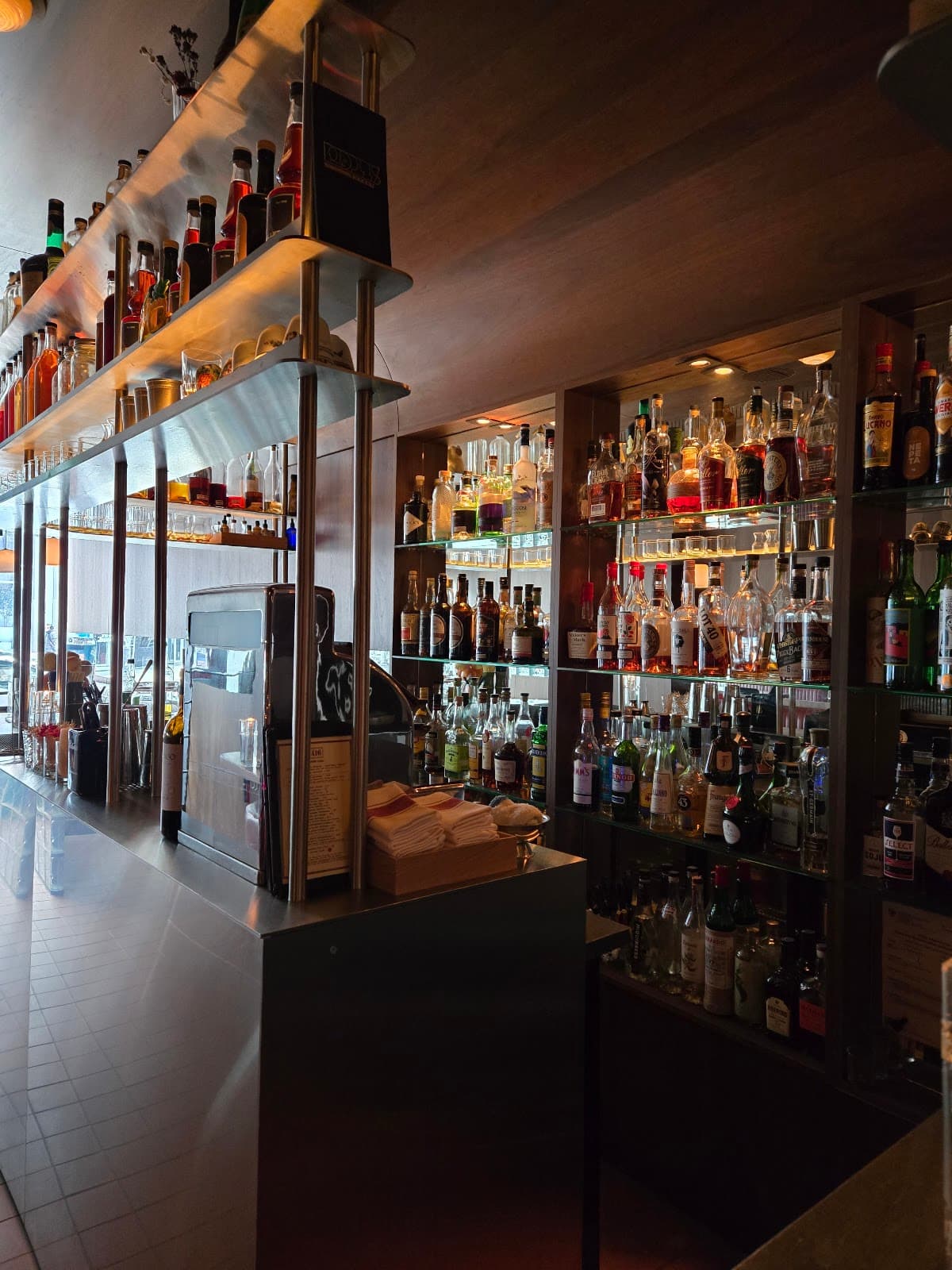 Close-up of a stocked bar with various bottles and bar equipment in Toronto
