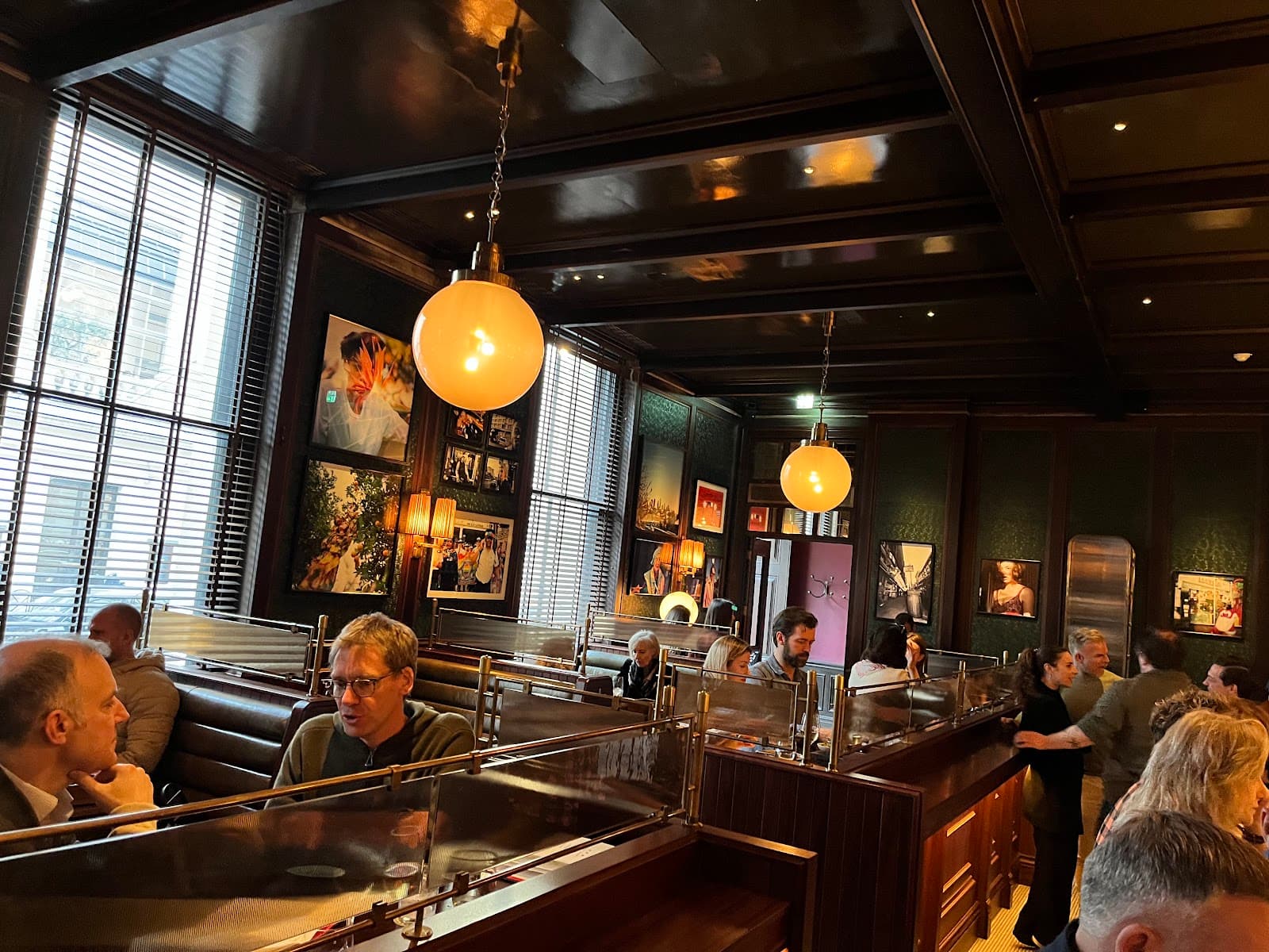 Stylish interior with leather booths, artwork, and large windows in London