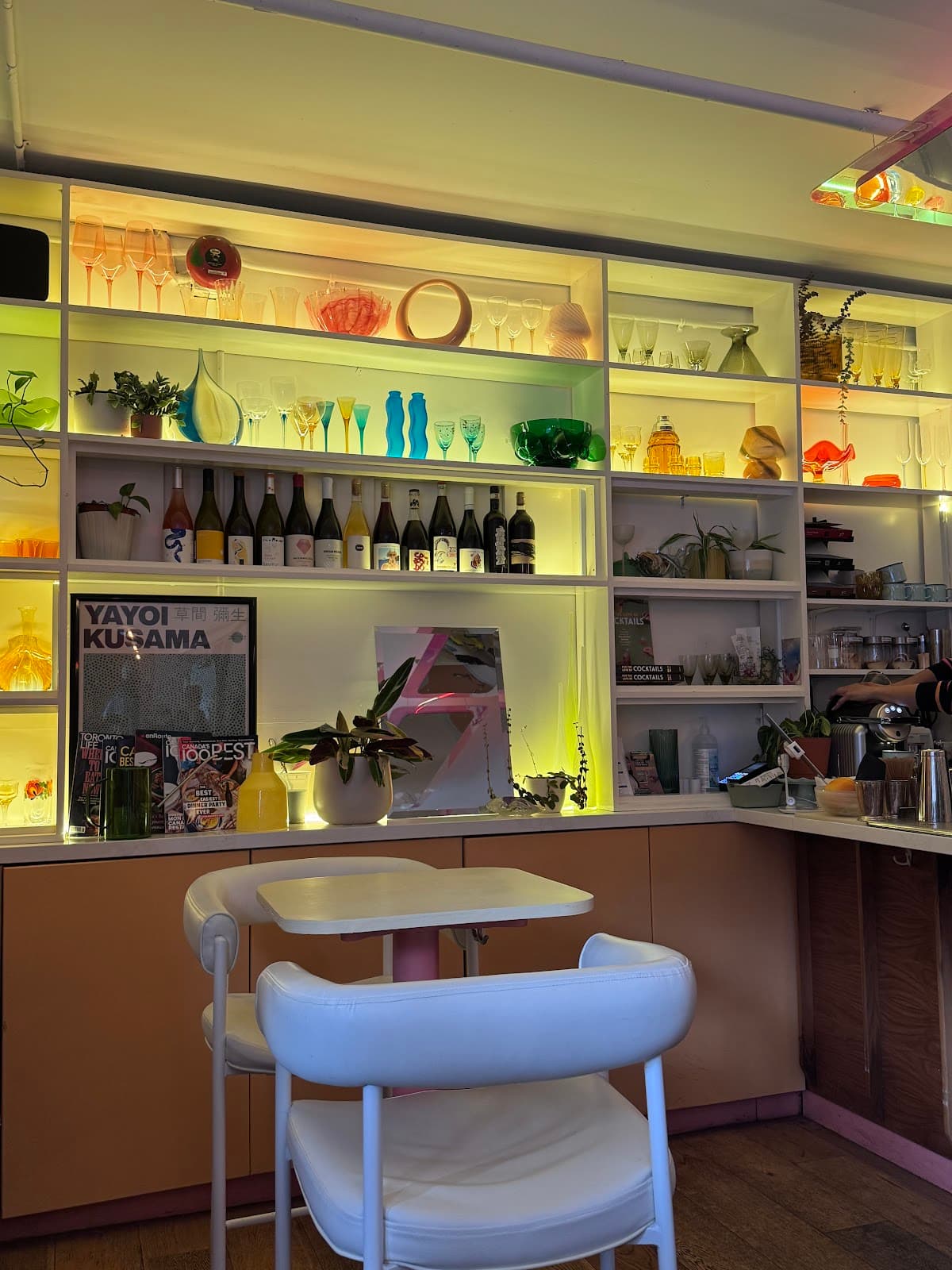 Colorful bar shelf with glassware and bottles at a cocktail venue in Toronto