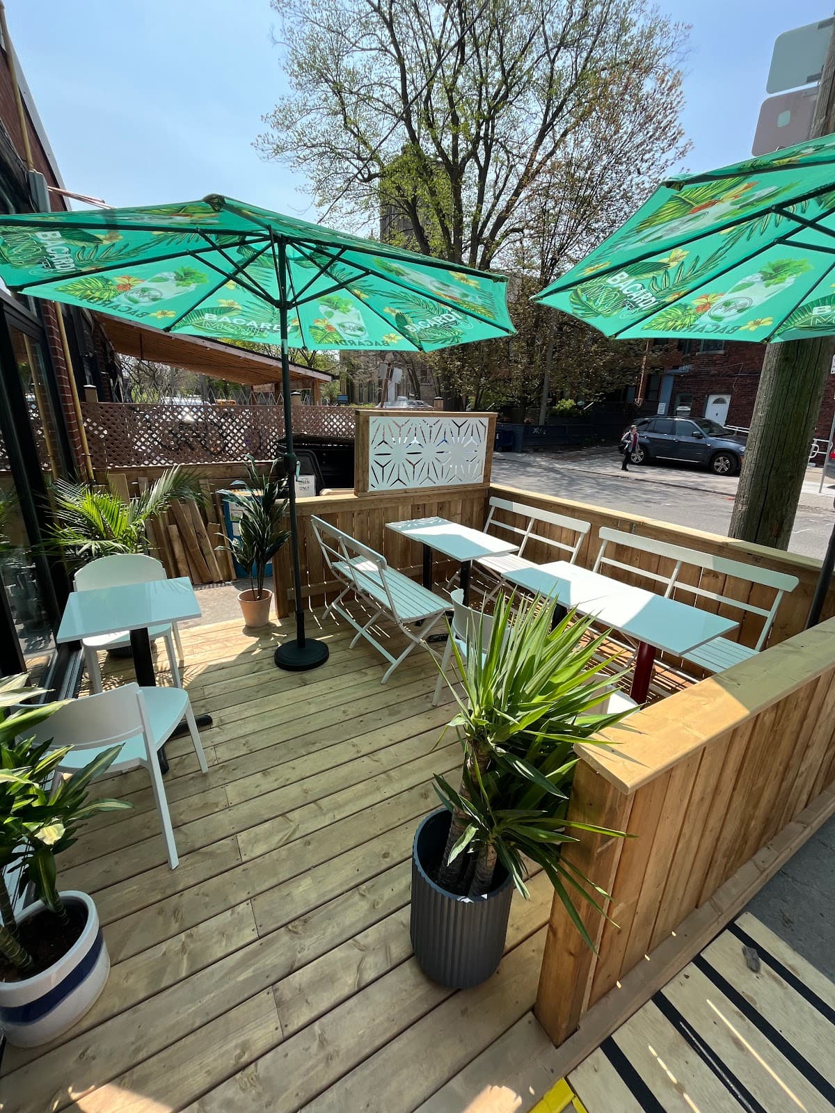 Outdoor patio with umbrellas and wooden seating area in Toronto