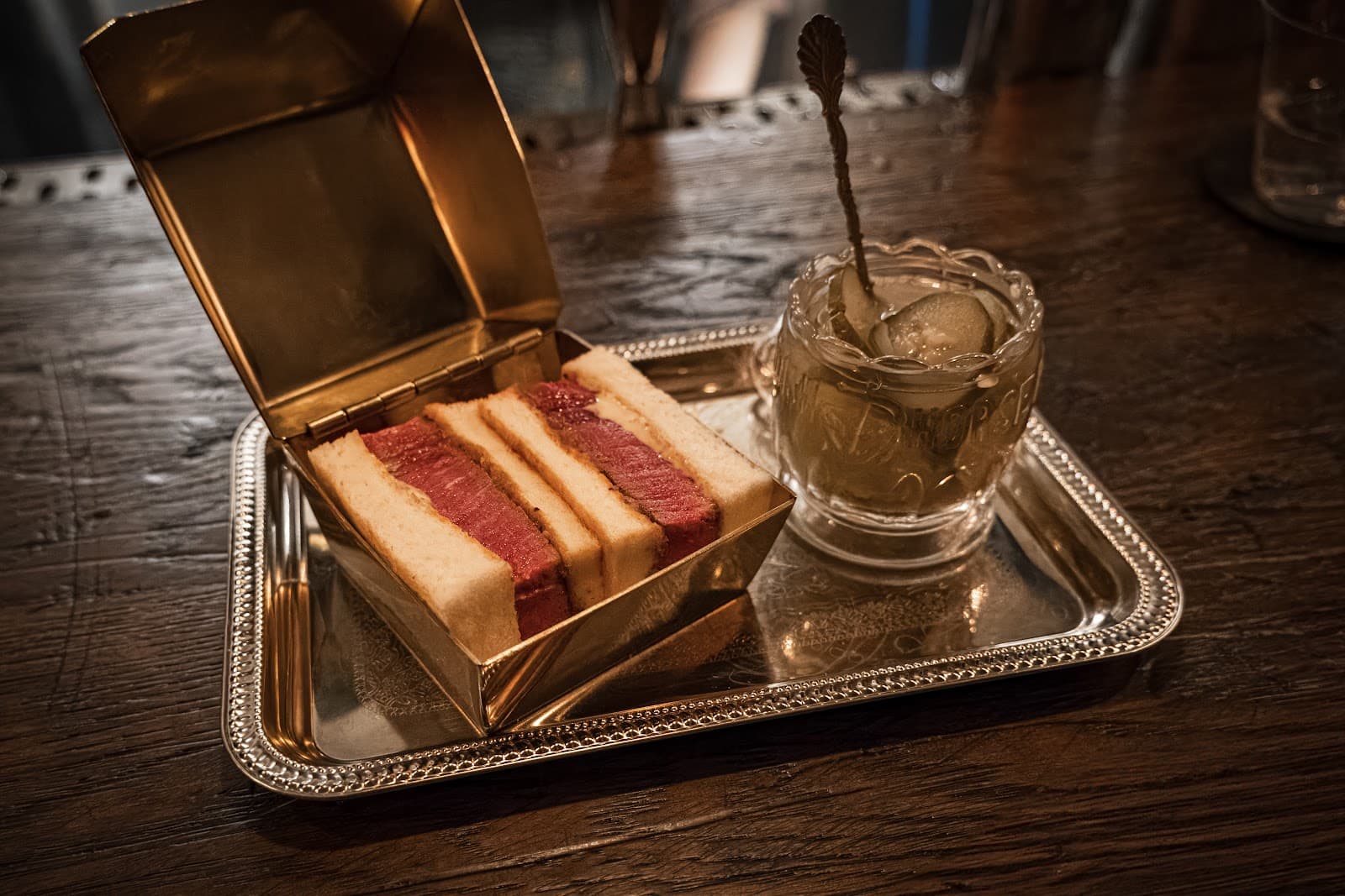 Elegant cocktail presentation with tray and sandwich box in New York