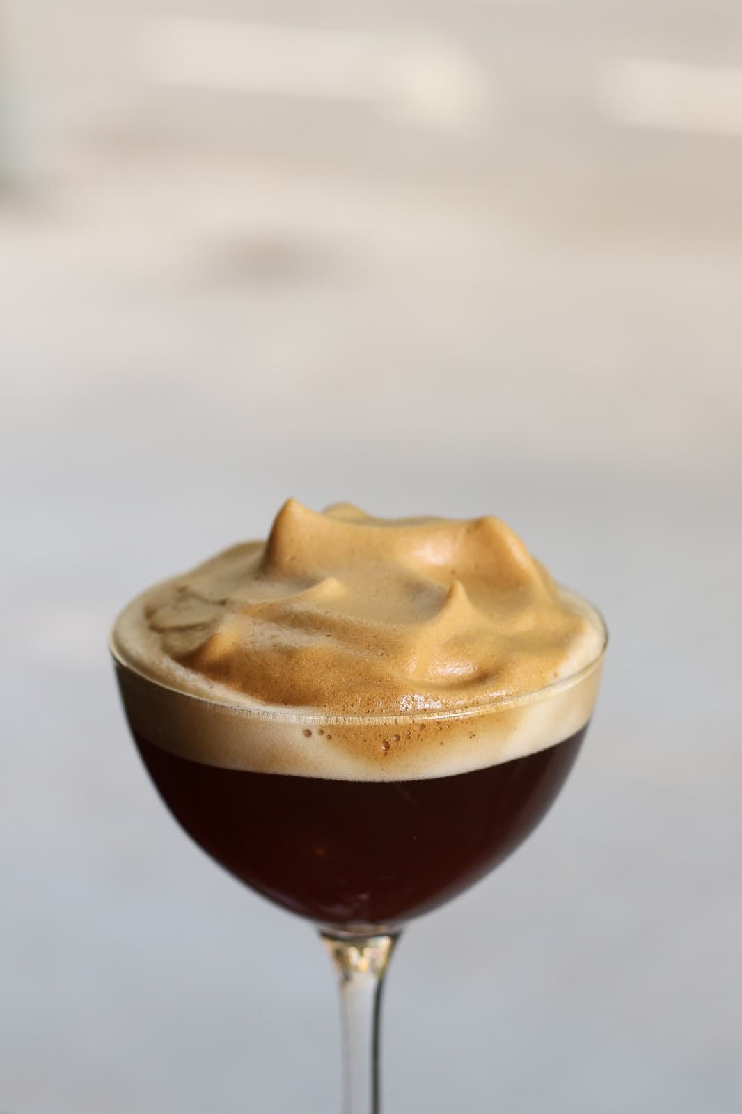 Close-up of a cocktail glass with frothy foam topping. in Barcelona