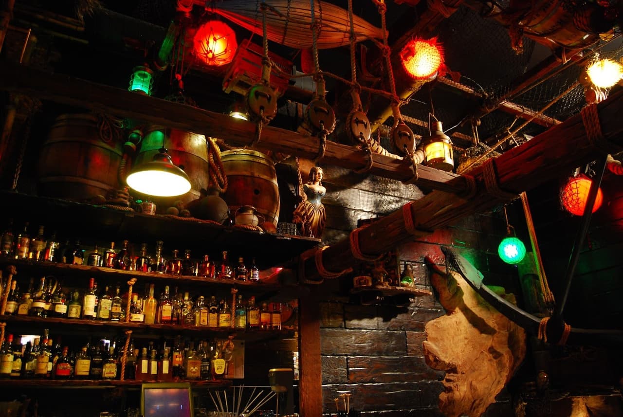 Eclectic bar interior with vibrant lighting and nautical decor