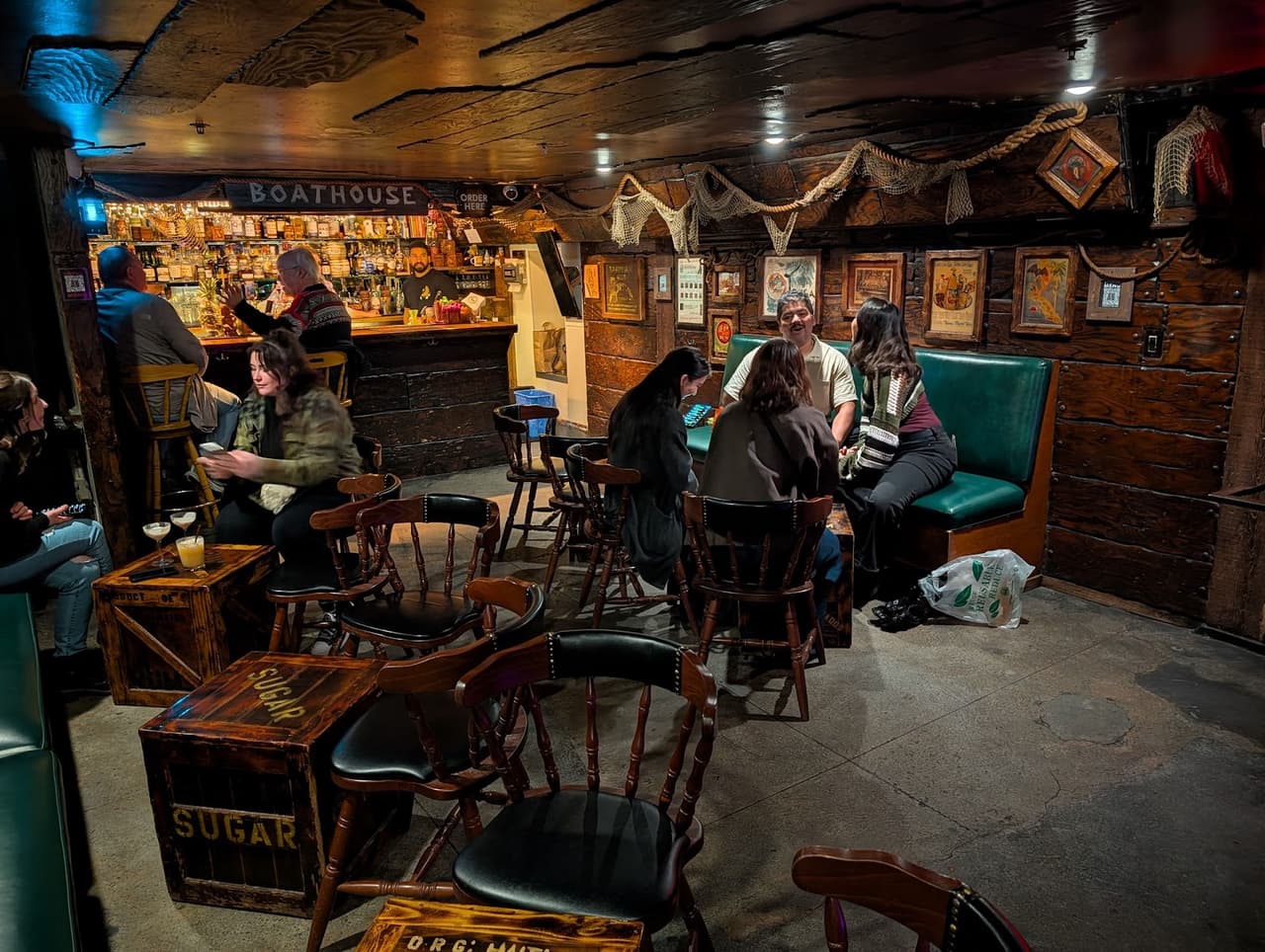 Cozy bar interior with wooden furniture and patrons at tables in San Francisco