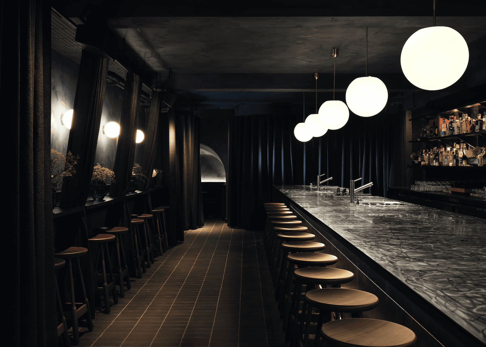 Elegant bar interior with marble counter and pendant lights
