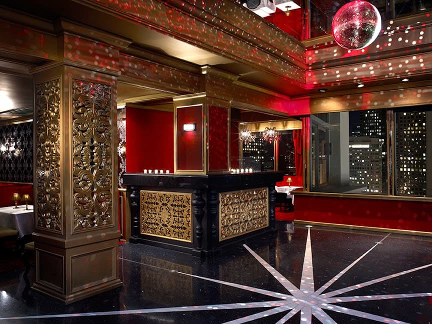 Luxurious bar interior with ornate columns and city view