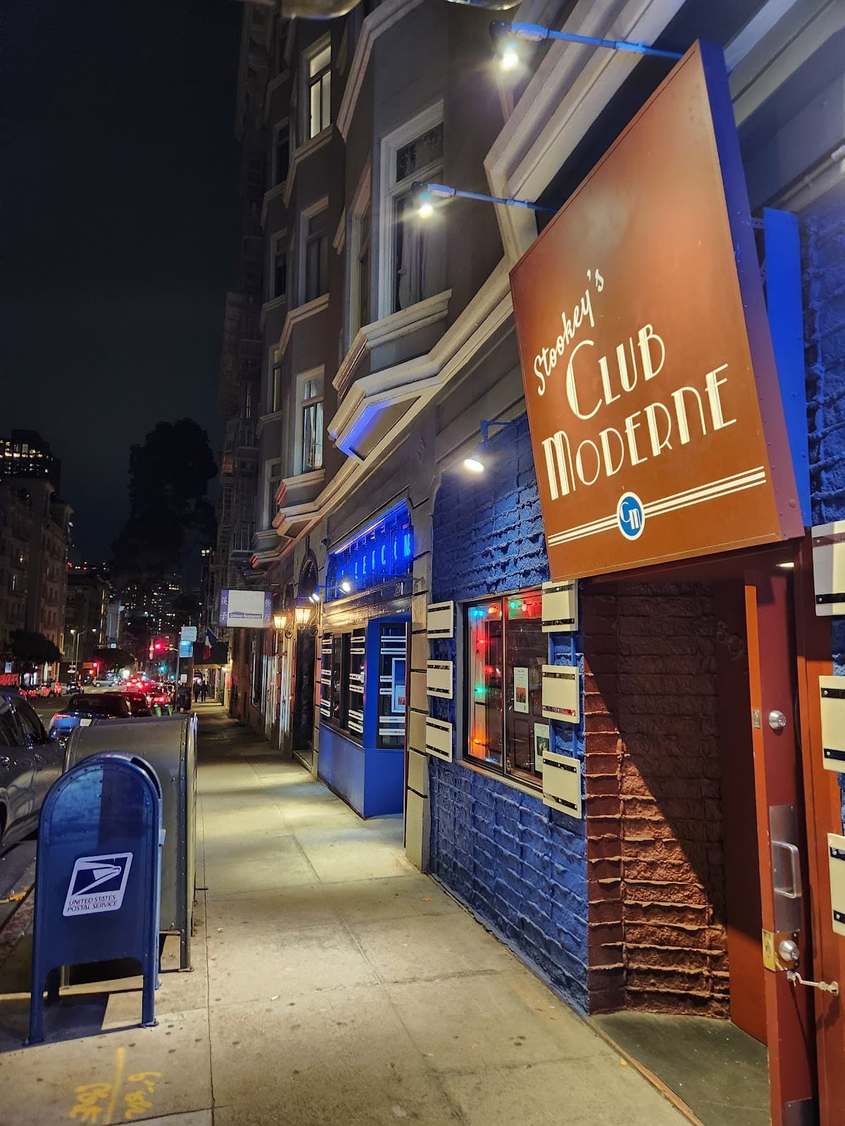 Exterior view of Stookey's Club Moderne with street lights shining in San Francisco