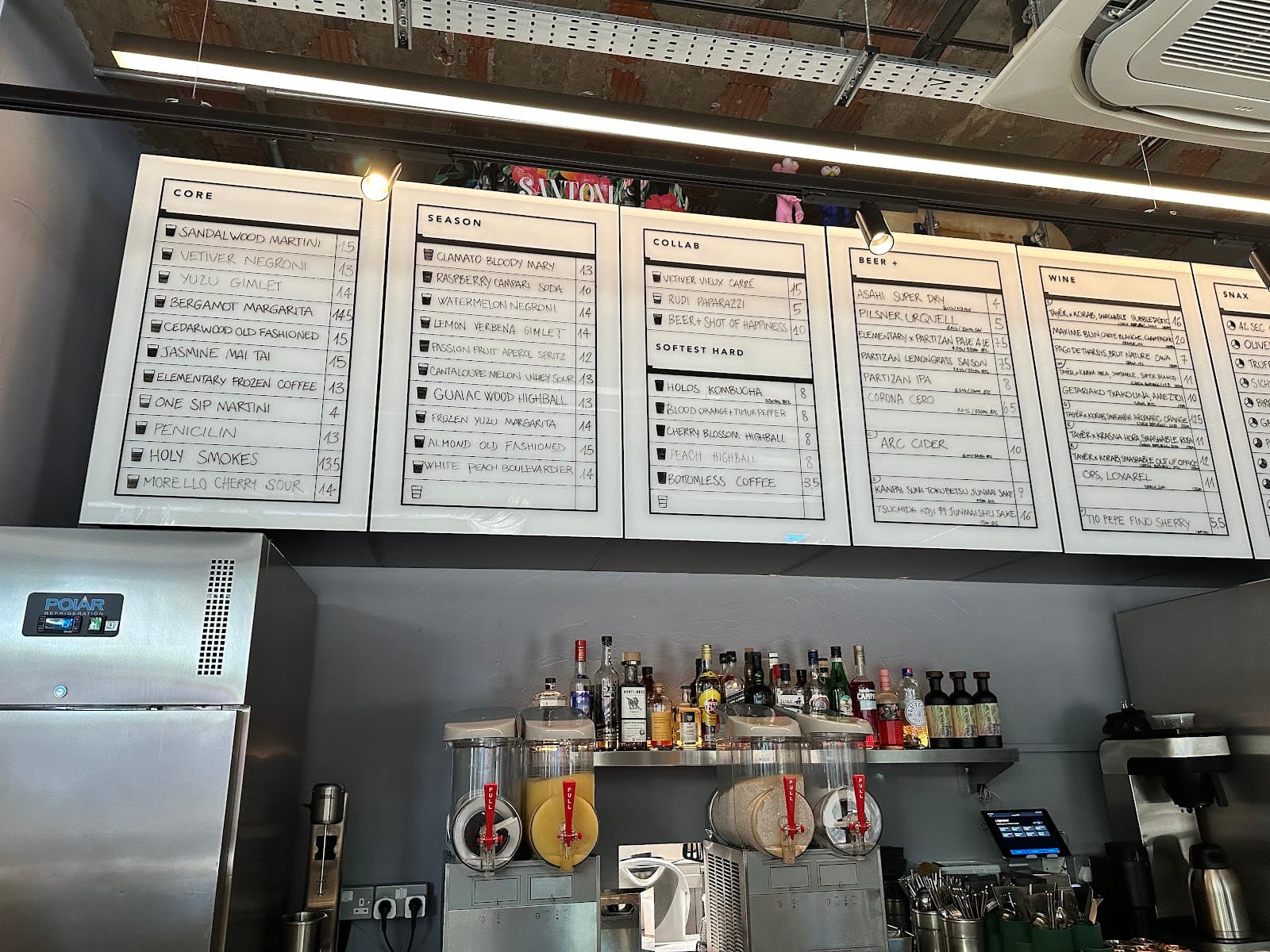 Bar area with menu boards and drink dispensers displayed in London