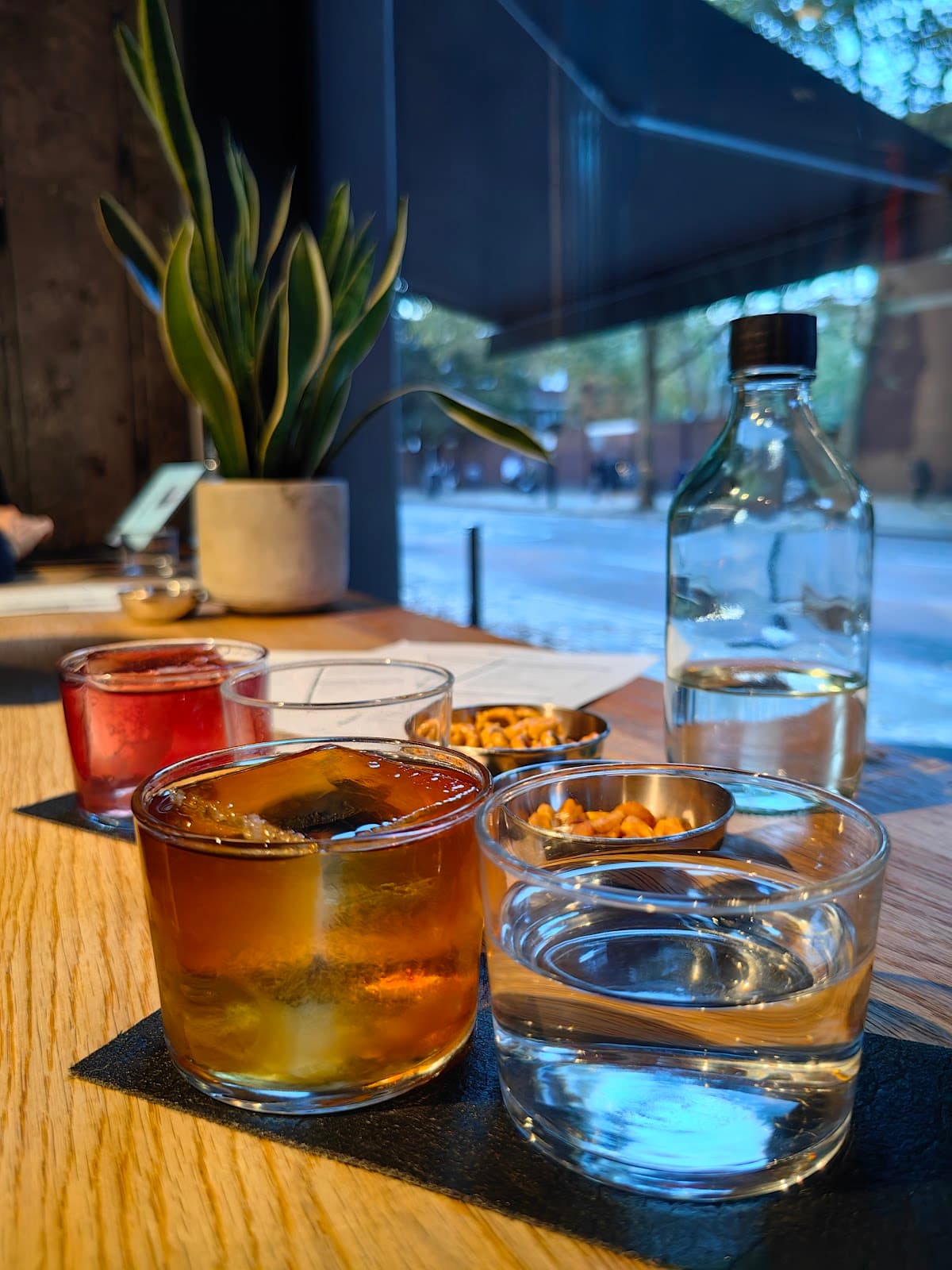 Close-up of cocktails with snacks on a wooden table in London