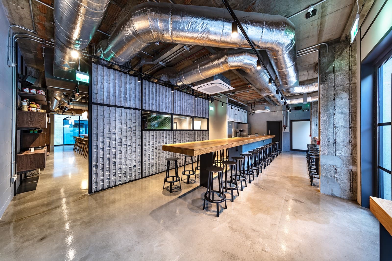 Modern interior with industrial decor and long wooden bar