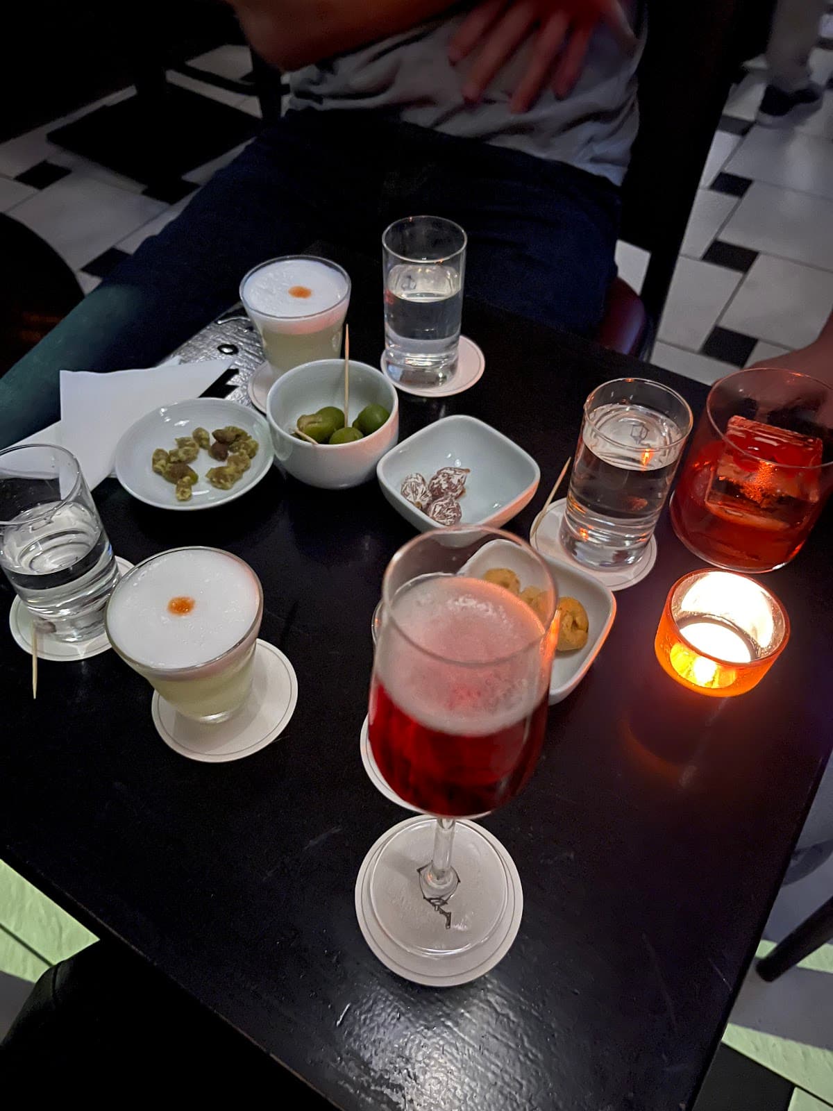 Table with drinks and appetizers in a cocktail bar in London