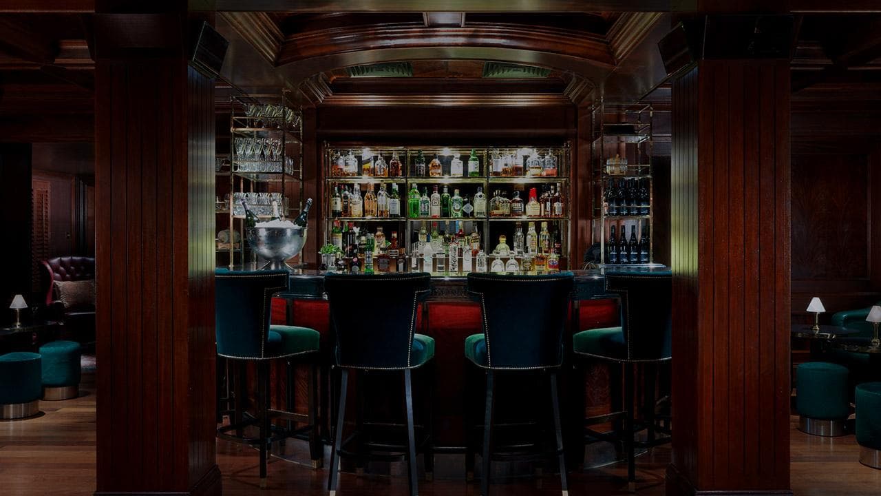 Elegant bar with wooden accents and a stocked liquor display