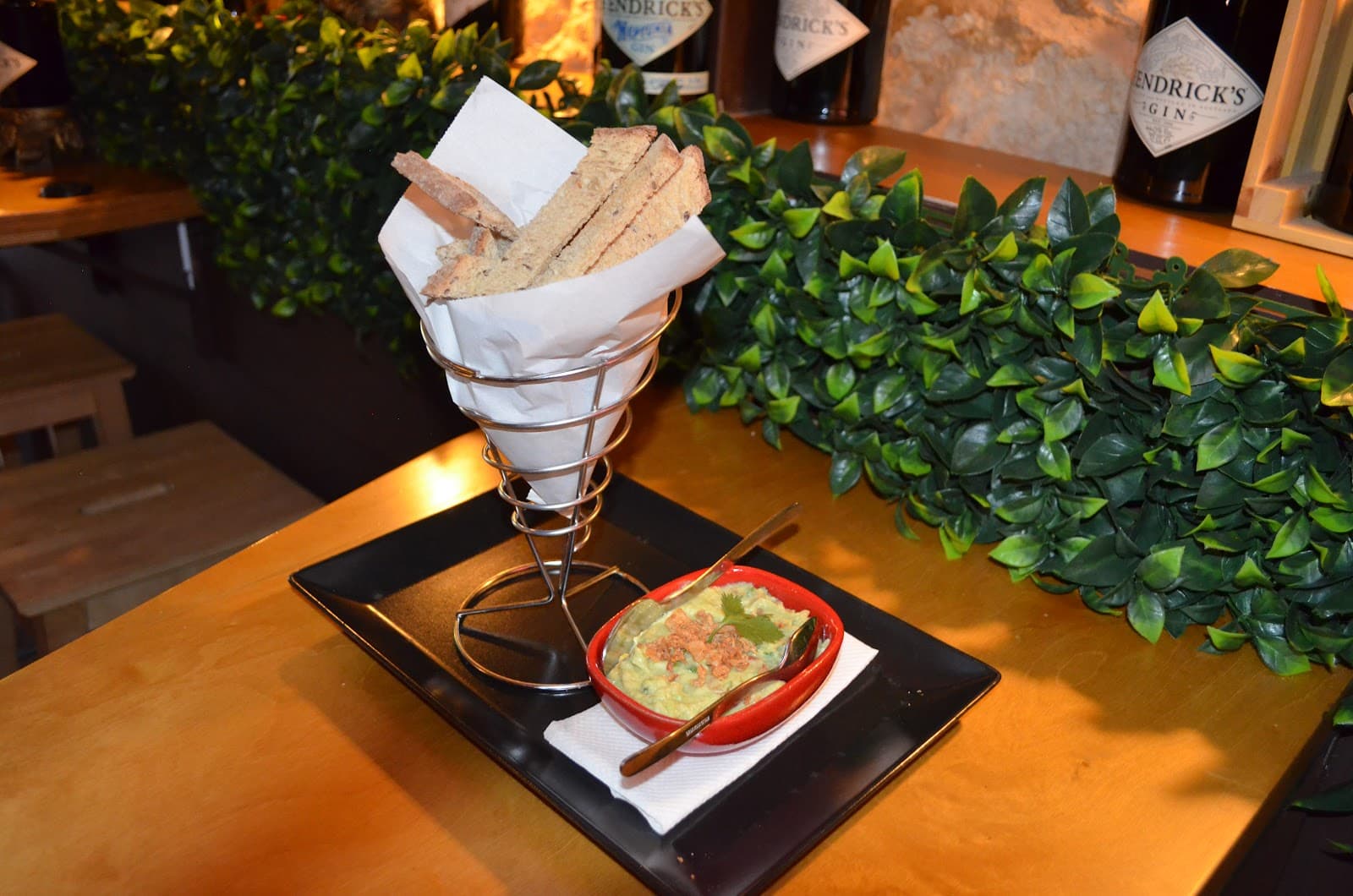 Bar snack of bread and dip with greenery in the background in Lisboa