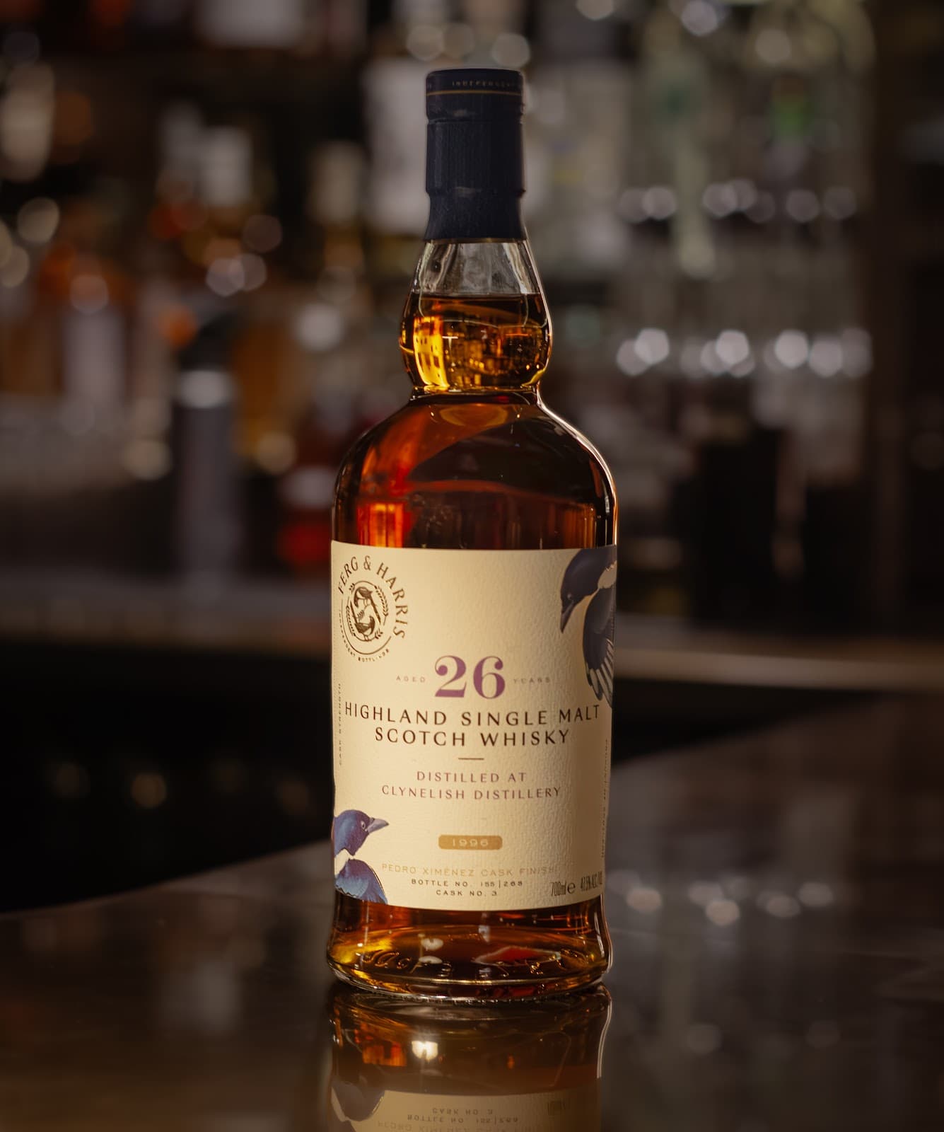 Close-up of a whisky bottle on a bar counter with blurred background in Edinburgh
