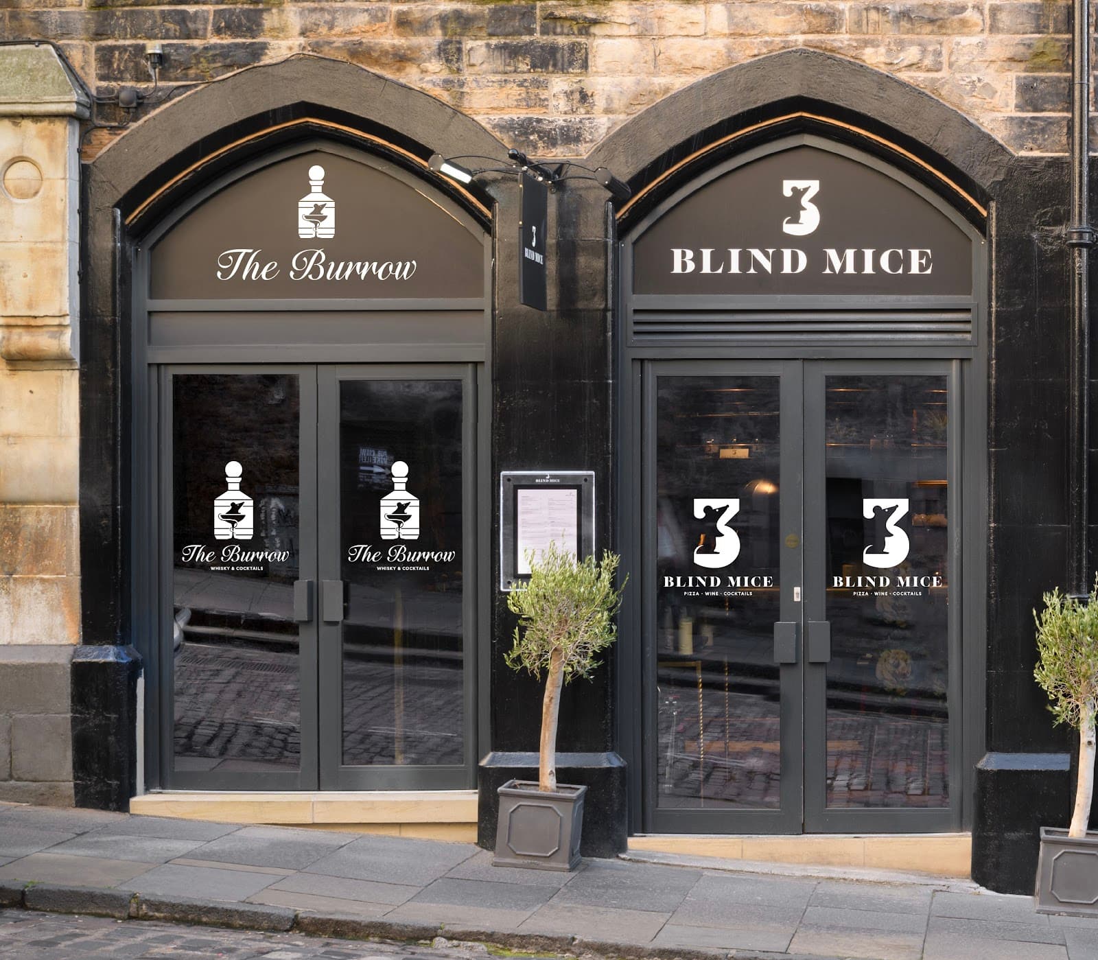 Exterior of The Burrow and 3 Blind Mice with glass doors and stone facade in Edinburgh