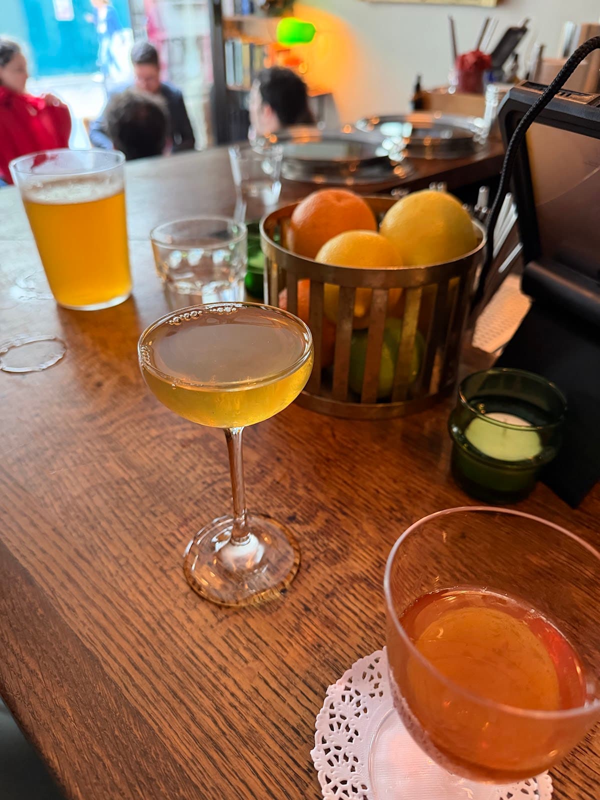 Close-up of cocktails on a bar counter with fruit basket in Paris