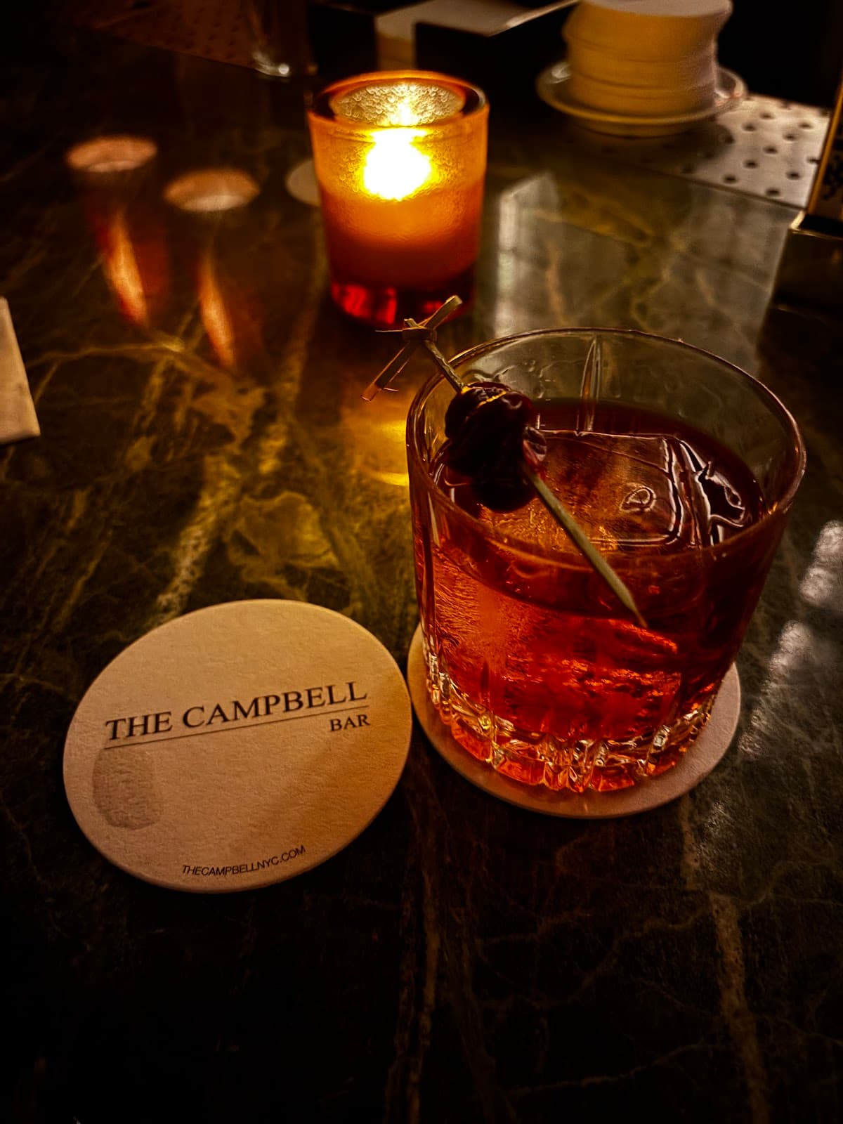 Close-up of cocktail glass with garnish on marble bar at The Campbell Bar in New York