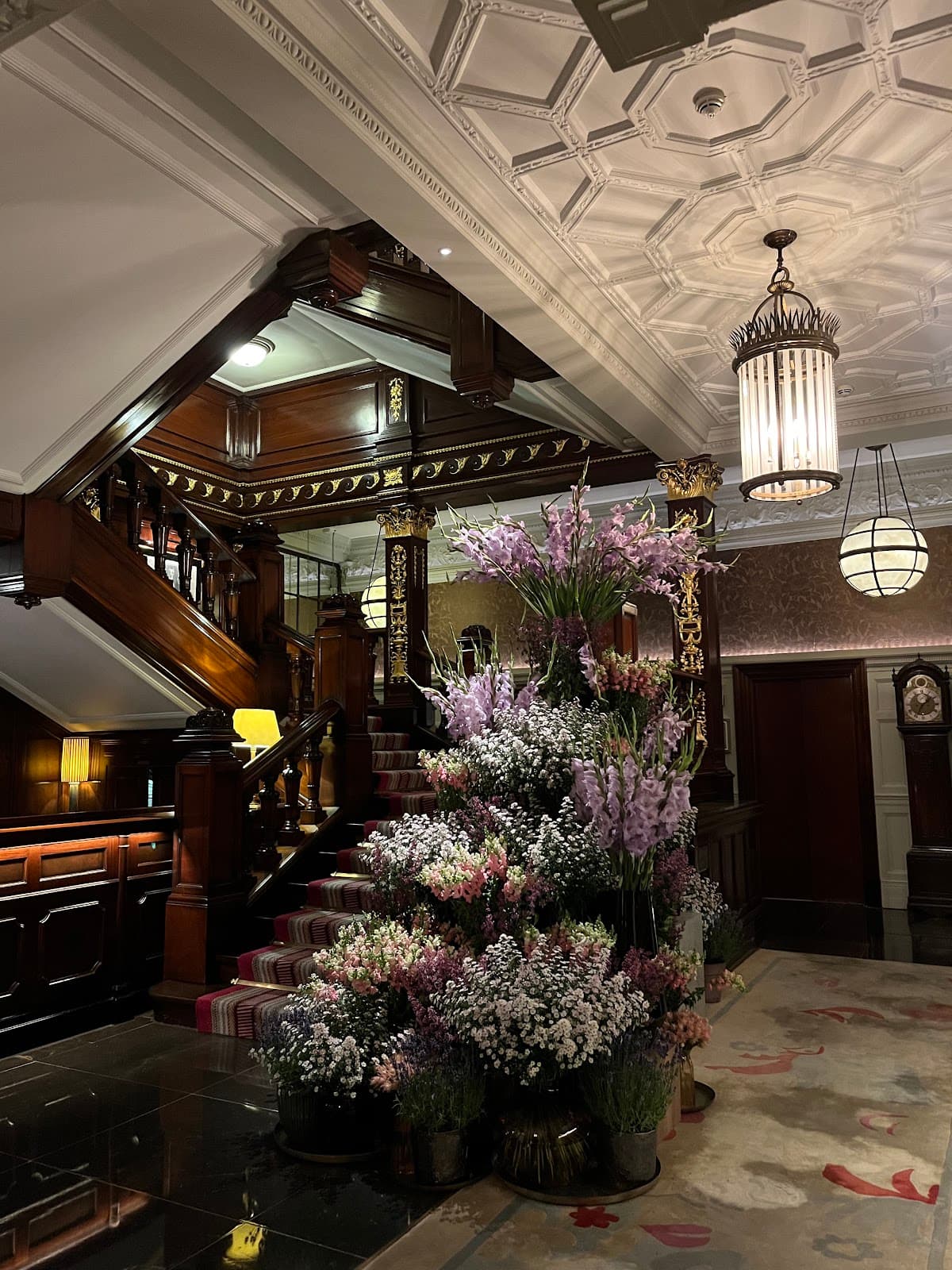 Elegant interior with floral display and ornate staircase in London
