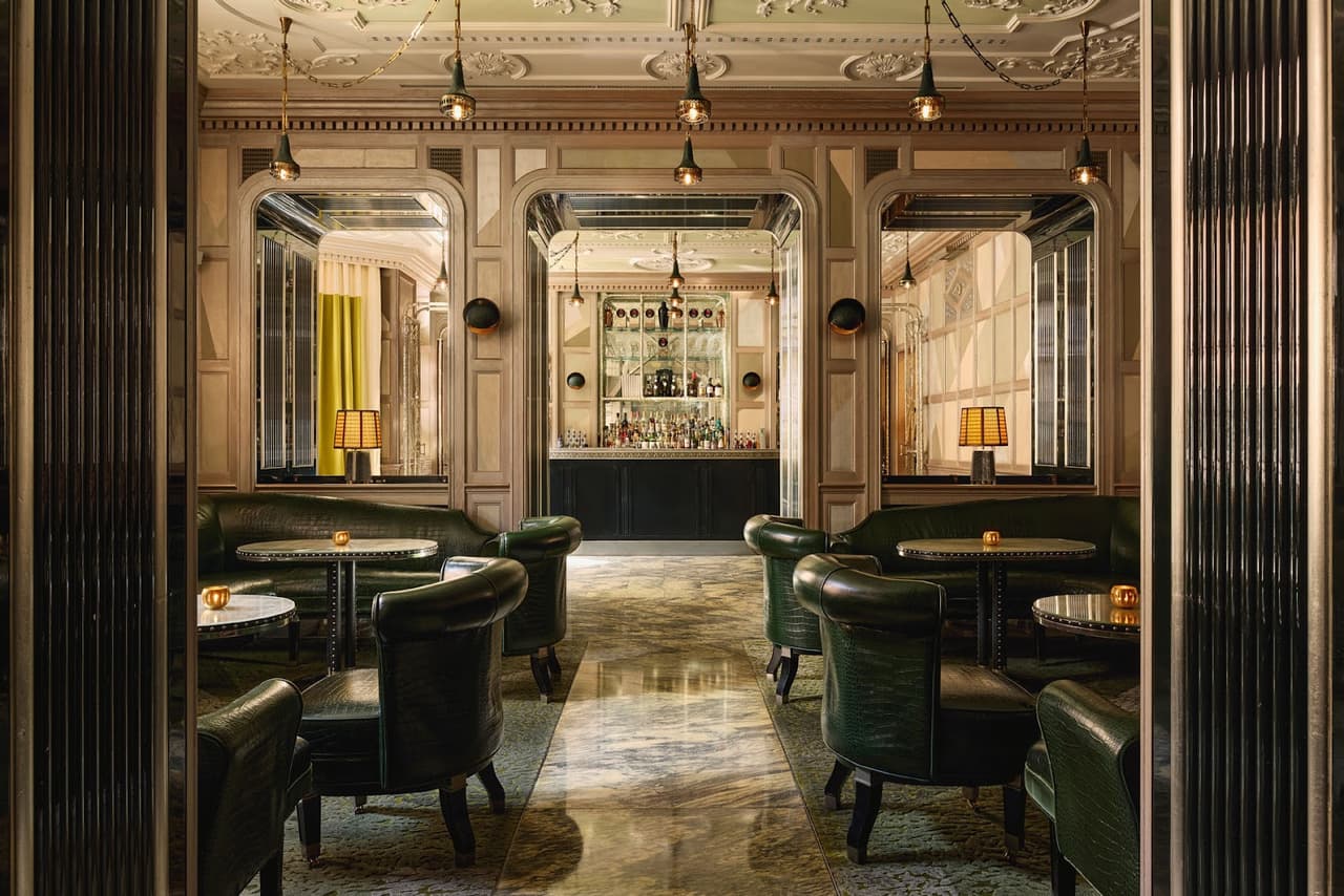 The Connaught Bar interior — green leather chairs and warm lighting, Mayfair London