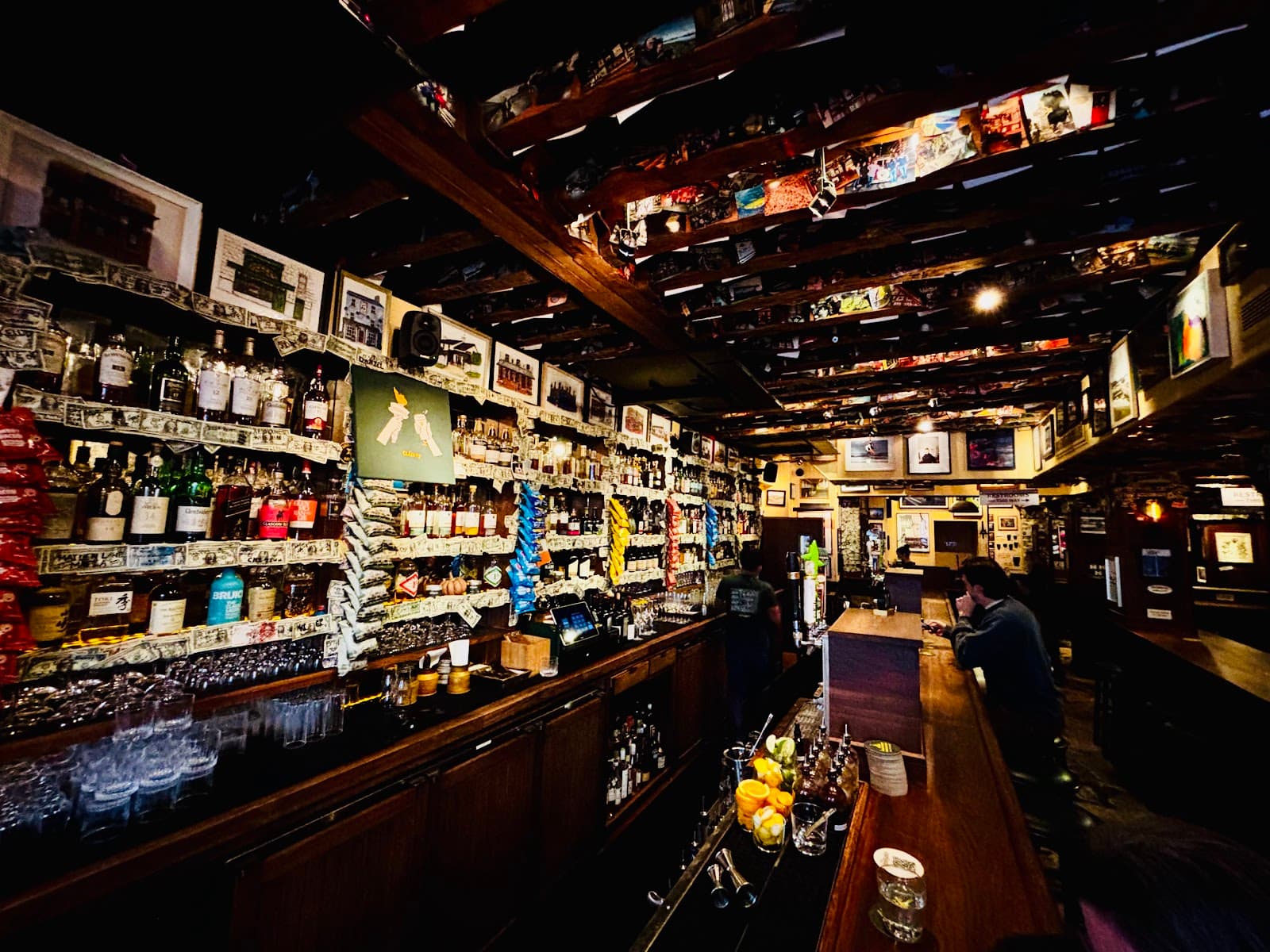 Bar interior with shelves of bottles and wooden counter in New York