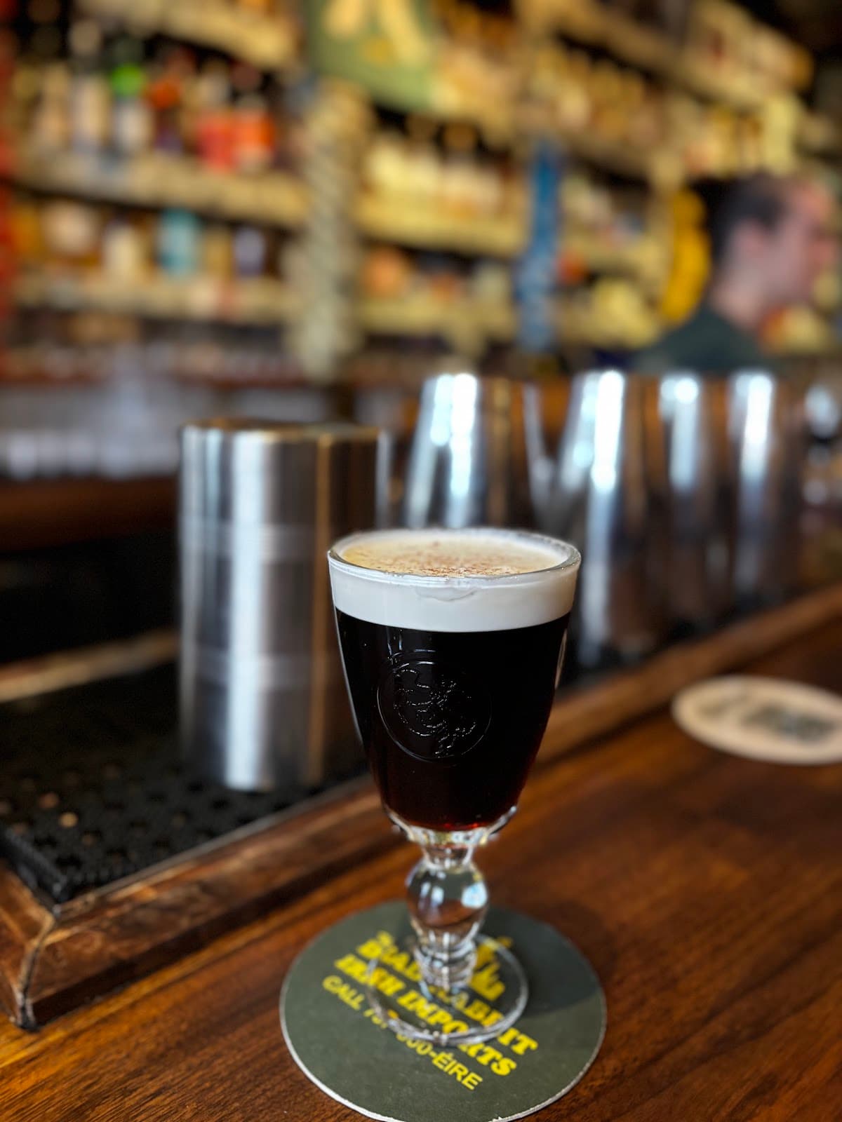 Close-up of a dark cocktail on the bar counter with blurred background in New York