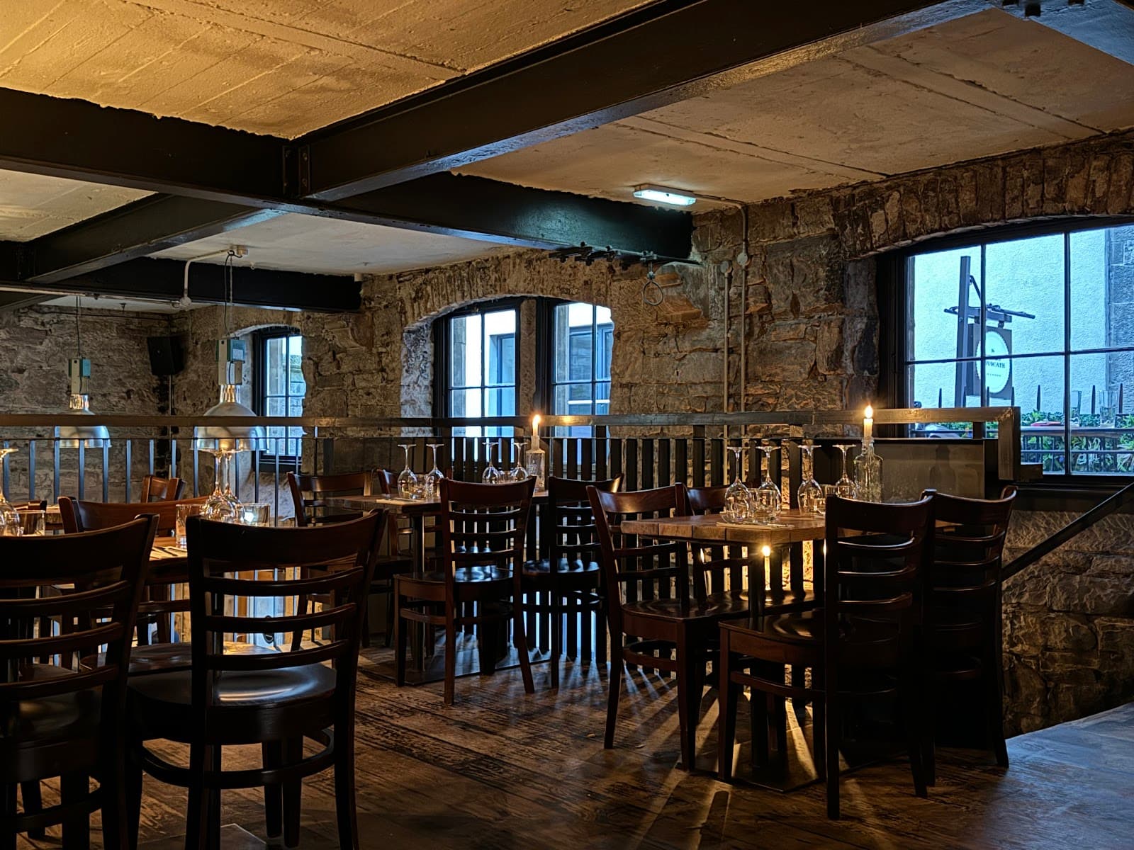 Cozy interior with rustic stone walls and candlelit tables in Edinburgh