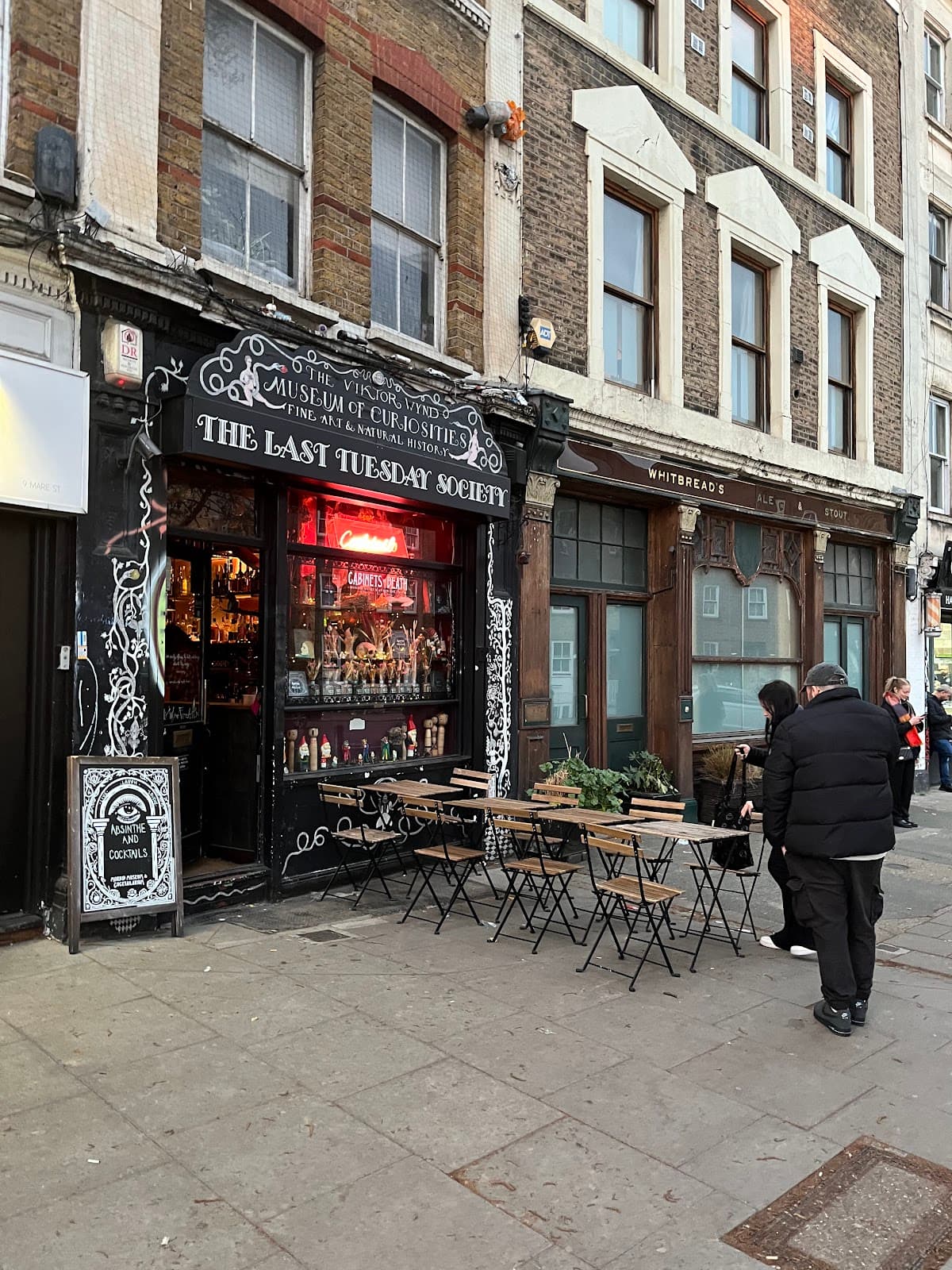 Front entrance of The Last Tuesday Society with outdoor seating in London