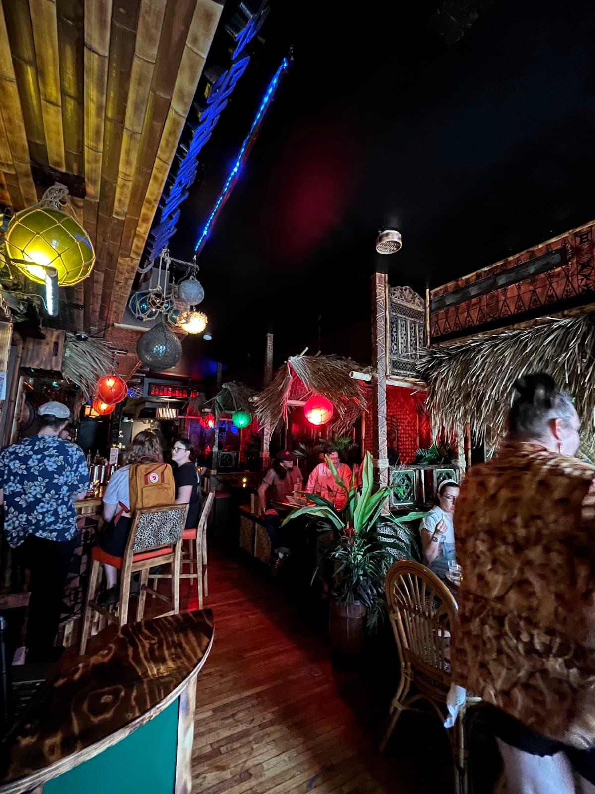 Tropical-themed bar interior with dim lighting and vibrant decor in Toronto