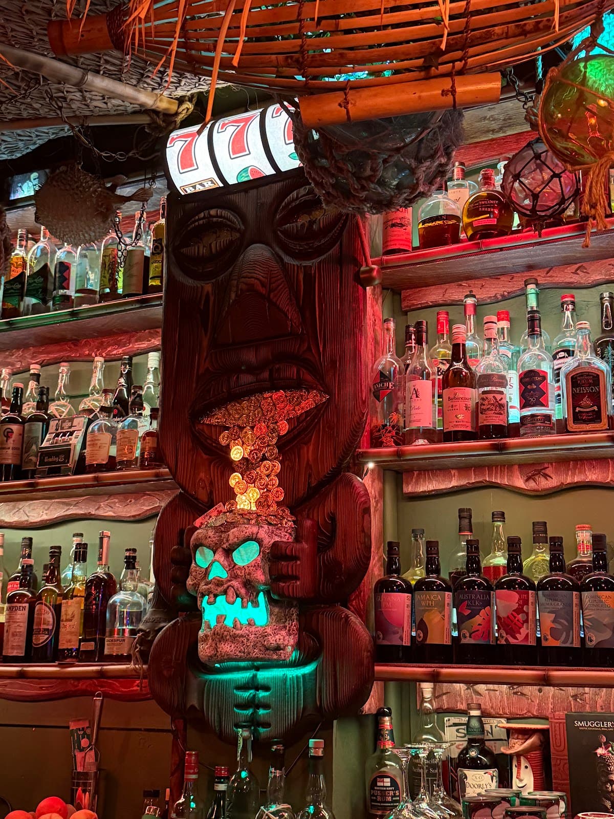 Decorative tiki-themed bar display with bottles and neon lighting in Toronto