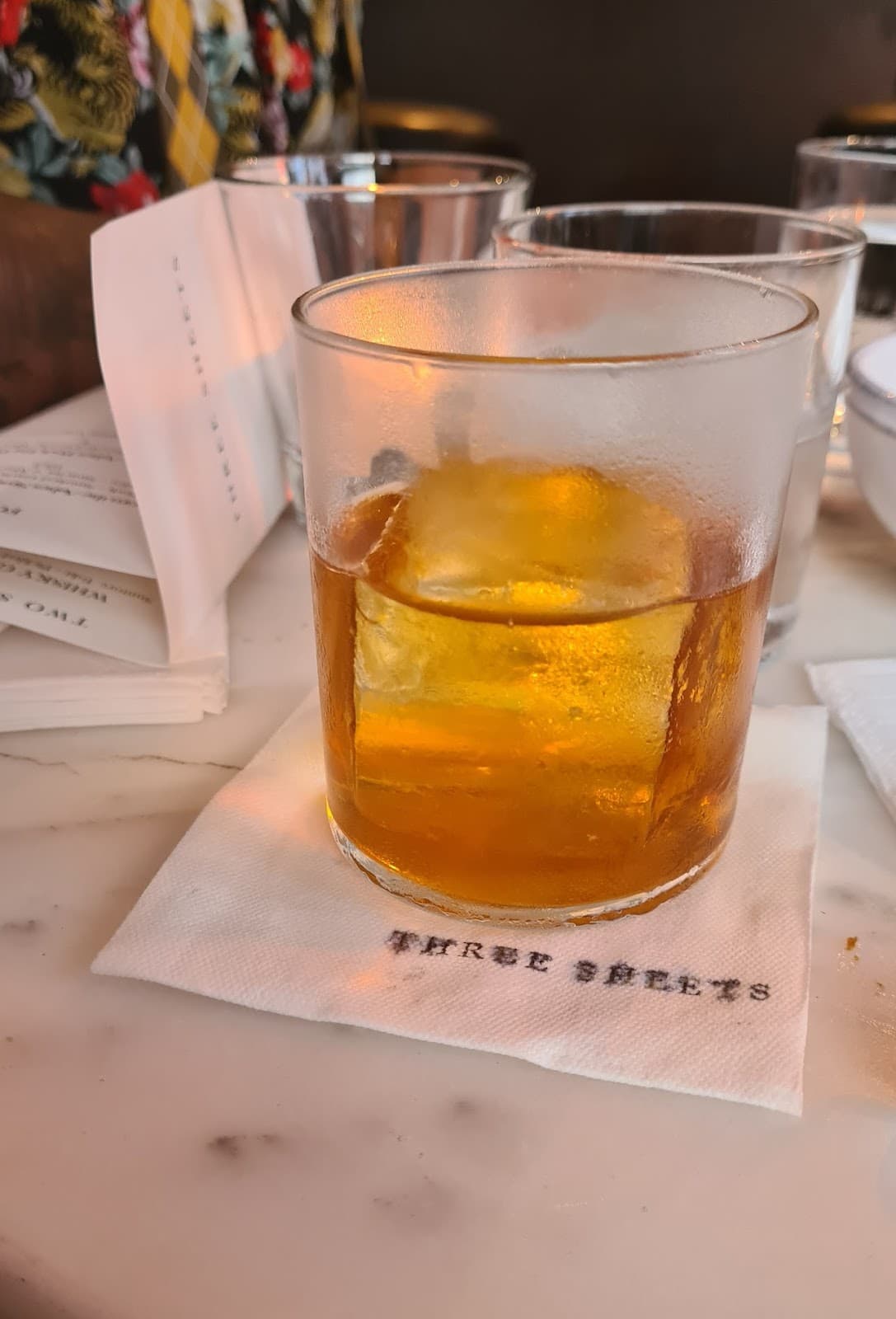 Close-up of an amber cocktail on a napkin at Three Sheets in London