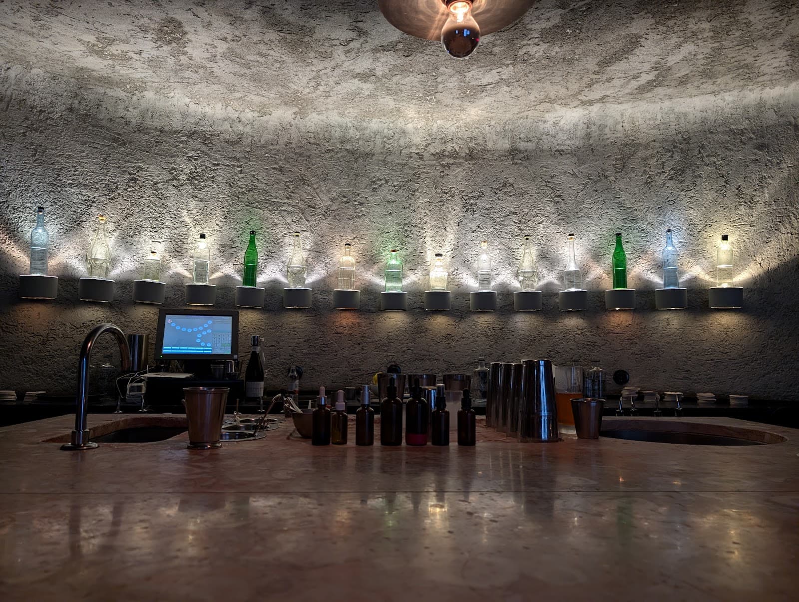 Elegant bar counter with bottles and modern lighting in Lisboa