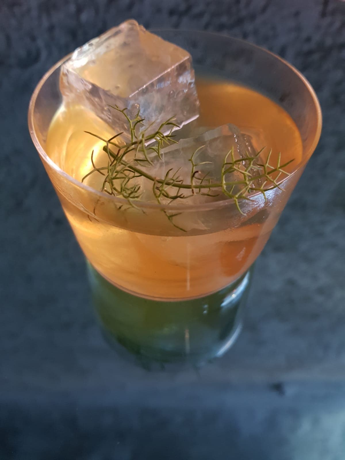 Close-up of a cocktail with ice cubes and garnish on a dark surface in Lisboa