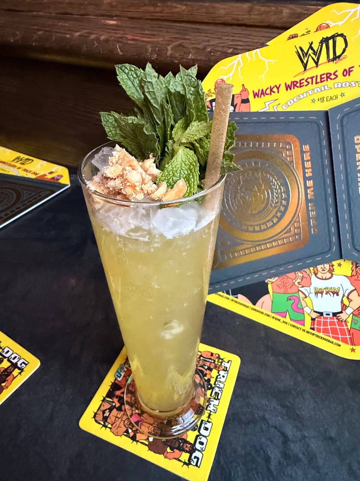 Refreshing cocktail garnished with mint and nuts, on themed coaster in San Francisco