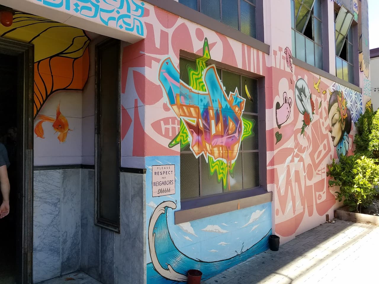 Colorful mural on building exterior with vibrant graffiti art