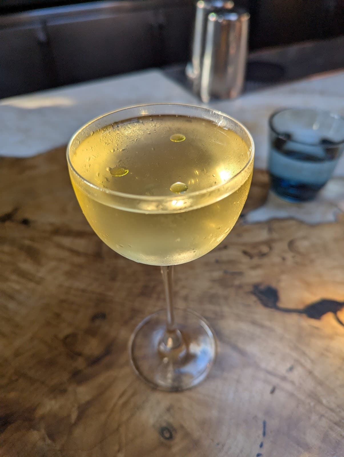 Close-up of a cocktail on a wooden table in a bar setting in San Francisco