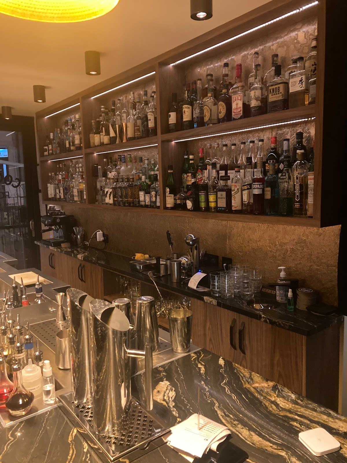 Well-stocked bar counter with bottles and mixers on display in London