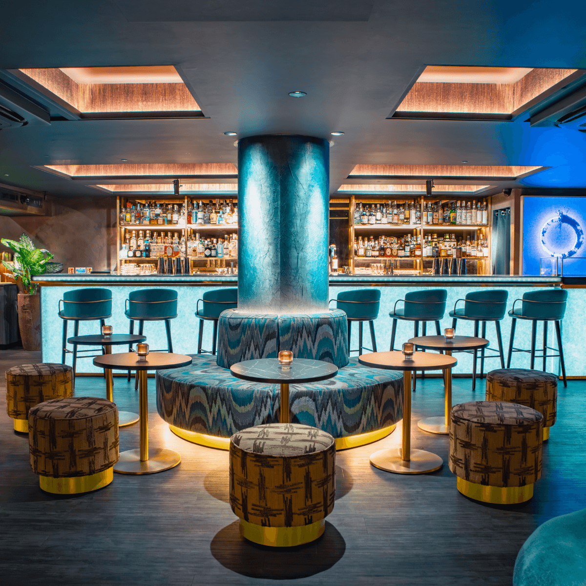 Modern interior of a cocktail bar with stylish seating and illuminated bar counter in London